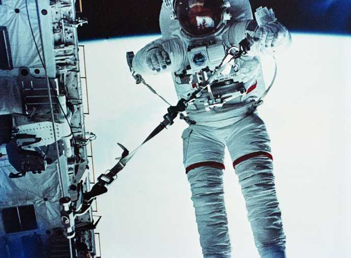 Astronaut F. Story Musgrave participates in a safety tether dynamics checkout procedure during the mission's April 7, 1983, extravehicular activity, otherwise known as EVA.  The earth is visible behind him.  (AP Photo/NASA)
