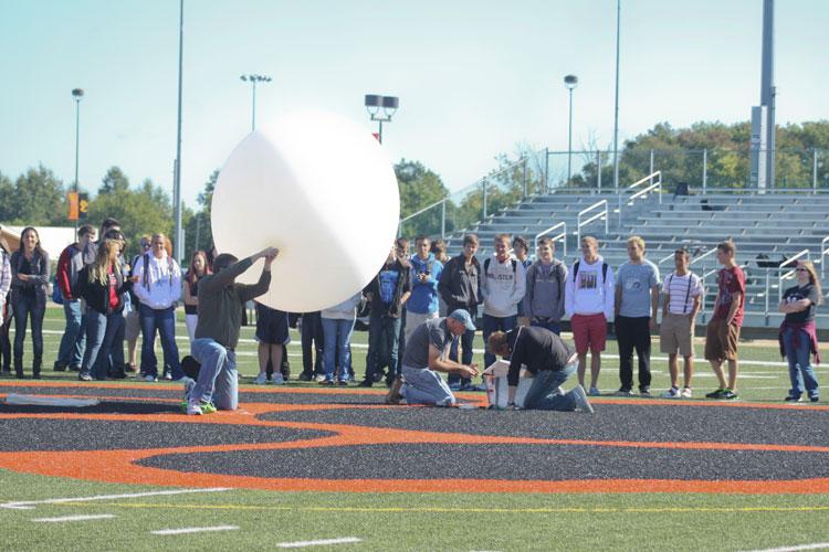 AP Human Geography teacher Kevin Paur prepares the balloon for launch. Within two minutes after the launch, the balloon had reached an altitude of 1,400 feet.