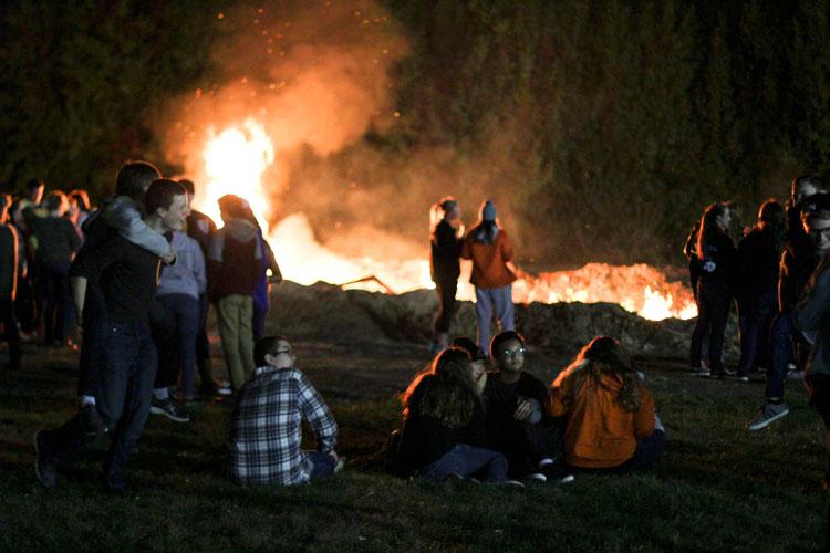 Students enjoy time by the fire on Oct. 23.