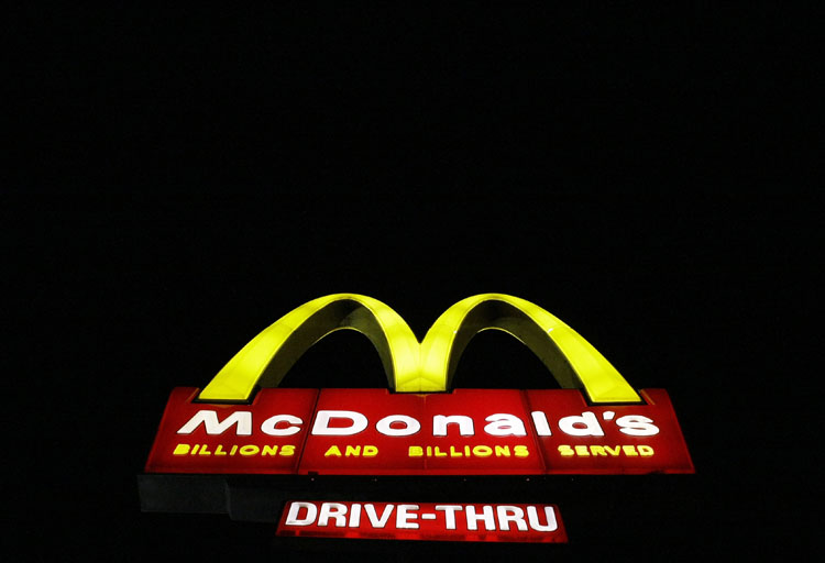 FILE - In this April 20, 2009, a  McDonald's restaurant sign is illuminated in the Wrigleyville neighborhood of Chicago. McDonald's said Thursday Dec. 10, 2009, it will begin selling a variety of breakfast items for $1 beginning in January, 2010.(AP Photo/Charles Rex Arbogast, file)