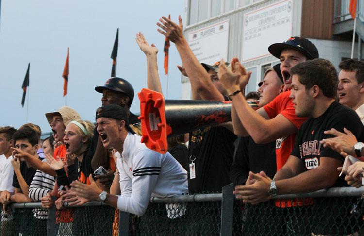 Students show their spirit while cheering on the Tigers at a soccer game. 