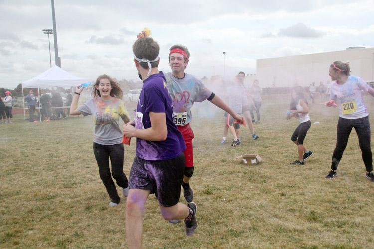 Students participate in the color fight at the end of the Red Ribbon Color Run. 