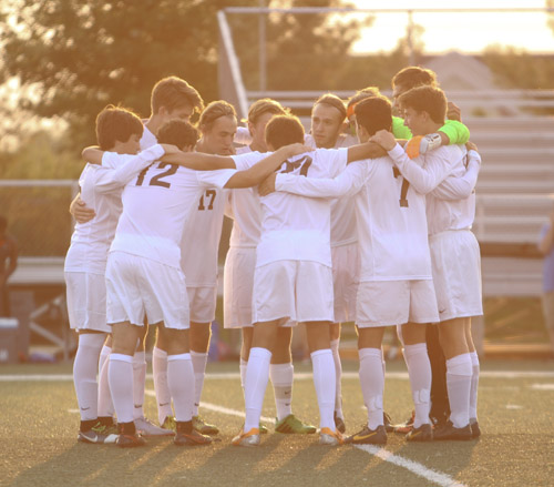 Tiger starters huddle before a regular season game against Granite City. The team ended their season 12-7-4. 