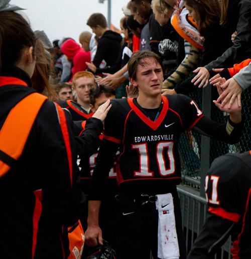 Junior Quarterback Brenden Dickmann high fives fans after falling 20-17 to Waubonsie Valley in the first round of IHSA playoffs ending the Tigers season 9-1. 