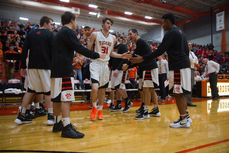 Junior Oliver Stephen high fives teammates before the game against Alton. 