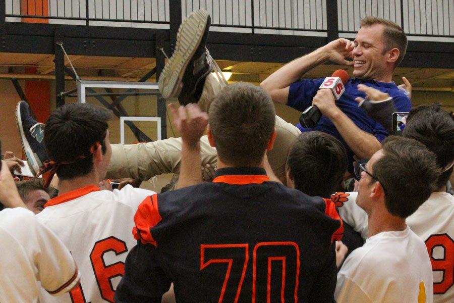 Ryan Dean crowd surfs on Orange Rush Friday morning at the Prep Rally