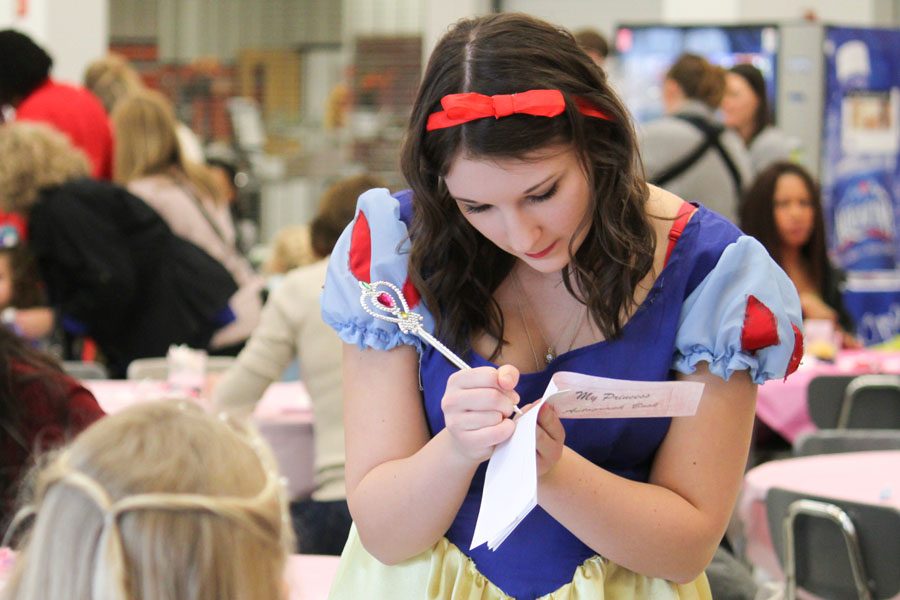 Senior Taylor Mateyka signs an autograph for a young fan.