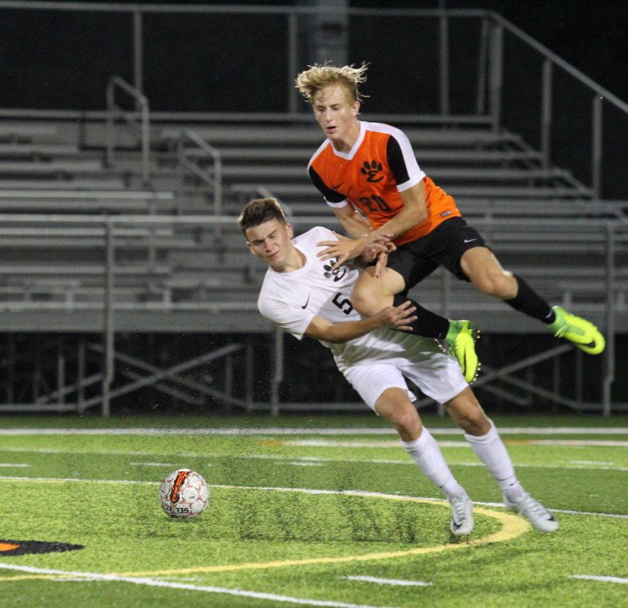 Junior Ashton Kaufman and Senior Bryce Broshow collide during the annual Orange and Black Scrimmage on Aug. 17.