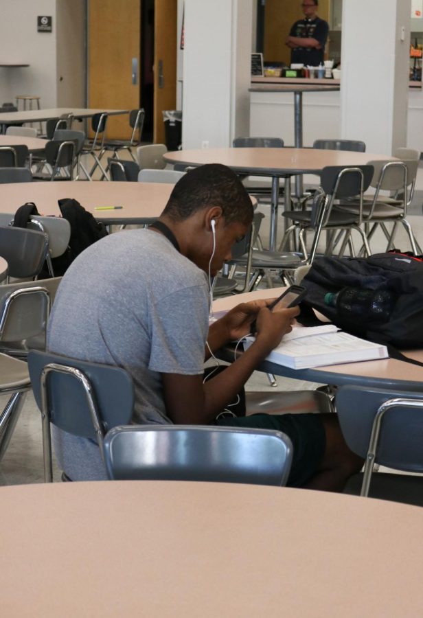 A student in the EHS Commons uses the new school Wi-Fi to check his Schoology account.