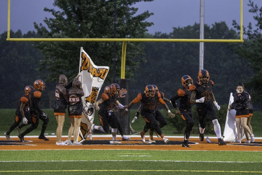 The EHS football team tears through the banner before the home game on Sept. 7.