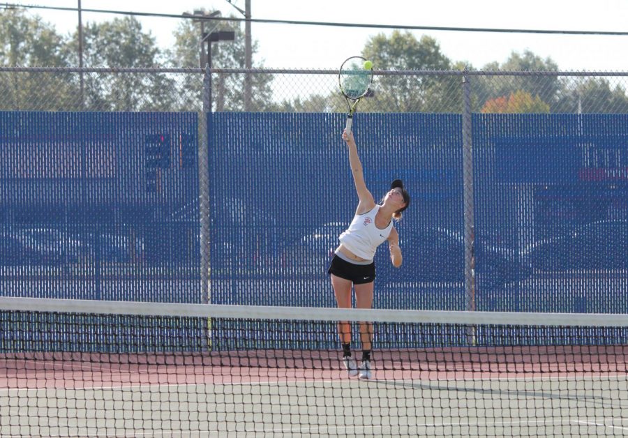 Senior+Annie+McGinnis+serves+the+ball+in+a+singles+match+against+Belleville+East.