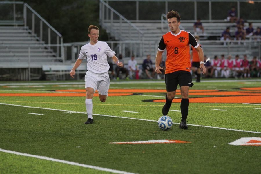 Senior captain Bryce Glisson looks to pass the ball to a teammate in a home game against Collinsville High School.