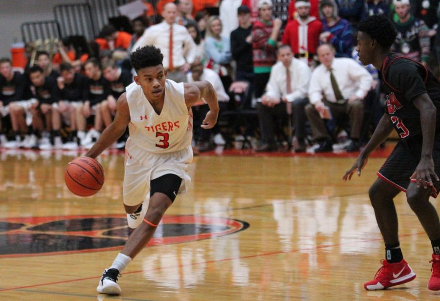 Senior Malik Robinson dribbles the ball down the court in a home game on Dec. 14.