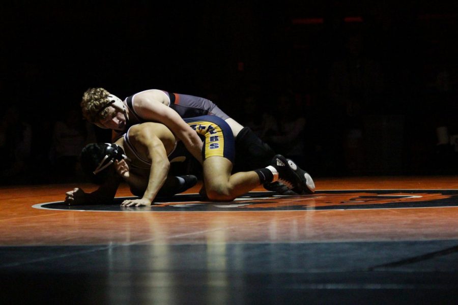 Senior Sam Martin tries to pin an opponent from O'Fallon Township High School on Dec. 29.