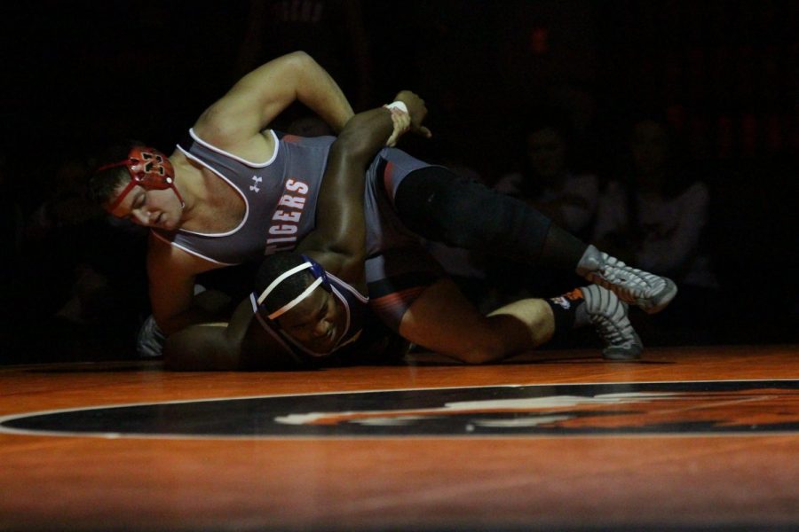 Senior Joshua Anderson pins an opponent from OFallon High School.