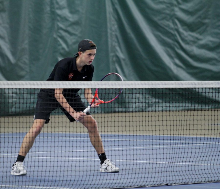 Senior Drake Schreiber prepares to return a serve on at a match on April 1.