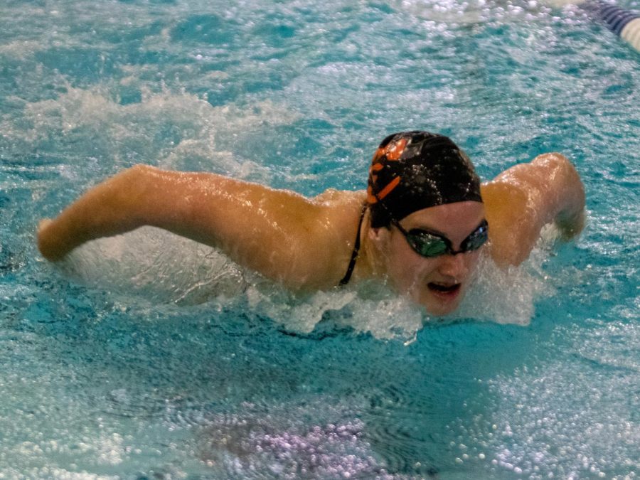 Freshman Josie O'Day swims the butterfly.