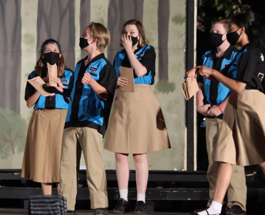 Lauren Bruss, Ryan Whaley, Austin Budwell, and other cast members perform in masks during the 2020 fall show, A Midsummer Nights Dream.