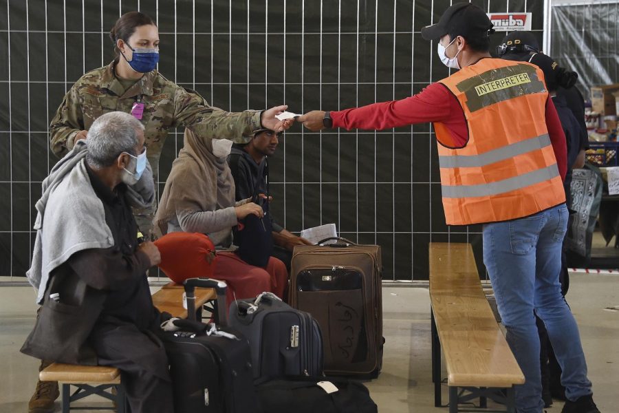 Afghan refugees receive aide at a German airport.