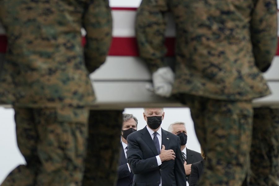 President Joe Biden watches as the remains of the 13 service members killed during the Kabul airport attack are carried off the transport at Dover Air Force Base.