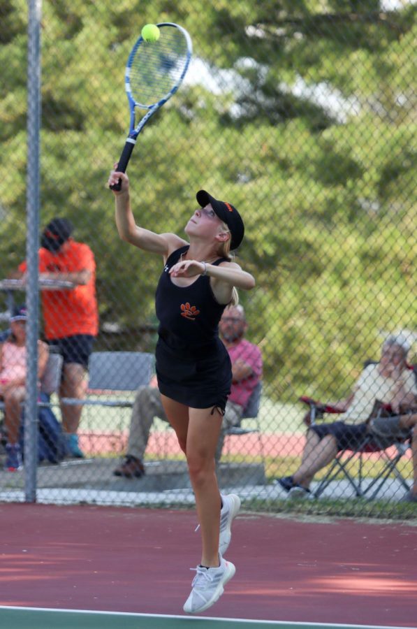 9th grader Madeline Bash reaches to return the ball in match against East St. Louis on September 13