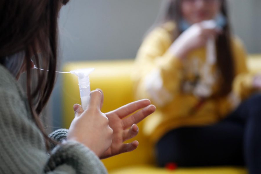 A child spits into a tube during a saliva COVID-19 testing session at the Niederau school in Strasbourg, France. These types of spit tests are being used at many high schools and universities across the world, including University of Illinois and EHS.