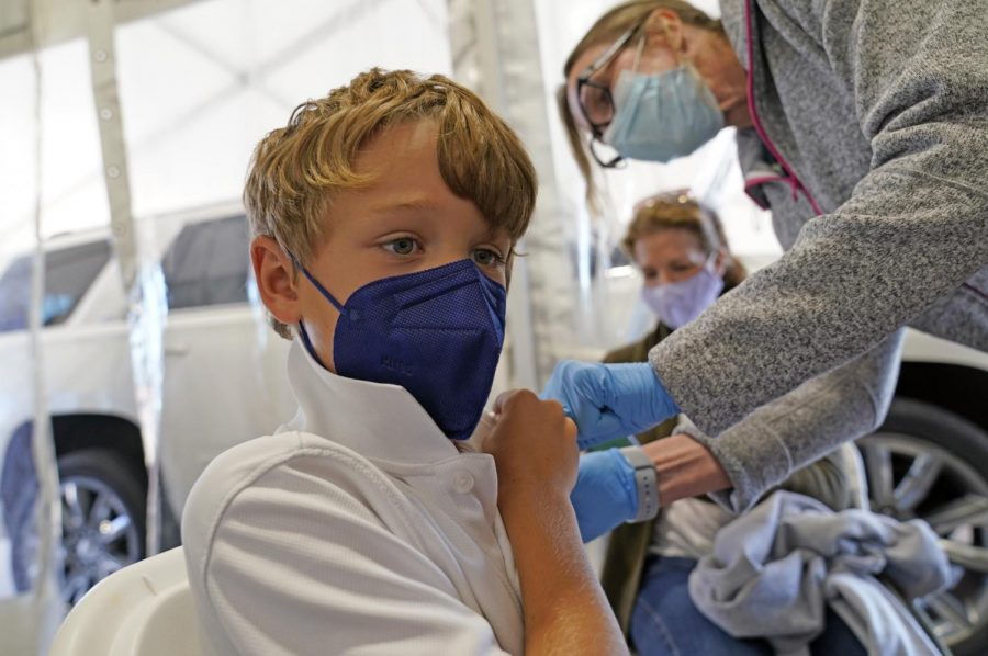 An 8-year-old receives the Pfizer vaccine after it was cleared by the FDA for emergency use. Shipments of child-size doses of the vaccine have already been shipped across the country. 