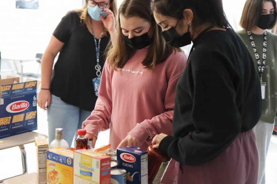 Members of Interact meet in Mrs. Pontious's room the week before Thanksgiving to assemble baskets.