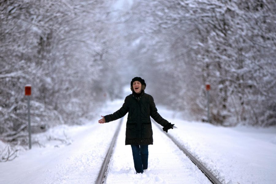 A woman walks in the snow after a snowstorm early in the year. 