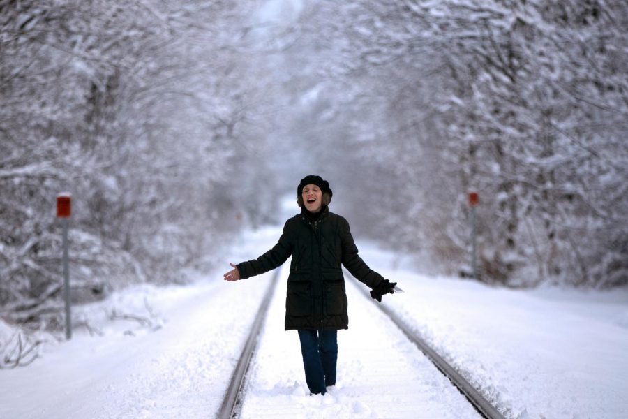 A+woman+walks+in+the+snow+after+a+snowstorm+early+in+the+year.+