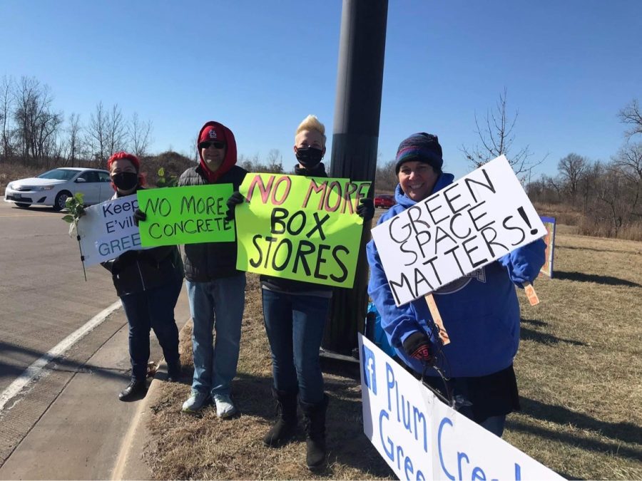 A group of protestors stand at the intersection between Plum Street and Governors Parkway behind Ross and Mens Wearhouse. Protestors are advocating that the land near Plum Street, which is being auctioned off, be used for something other than commercial development. 