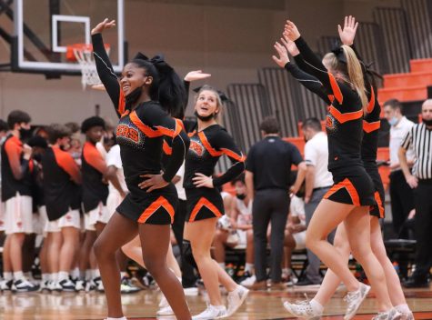 Sanaa Johnson, Allison Toma and other cheerleaders perform at a Dec. 14 boys basketball game