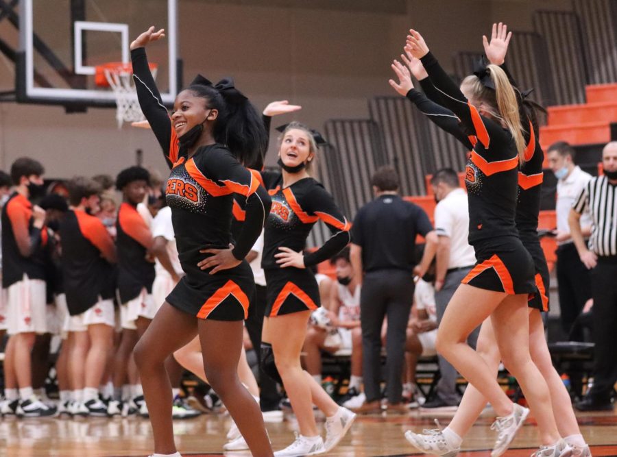 Sanaa Johnson, Allison Toma and other cheerleaders perform at a Dec. 14 boys basketball game