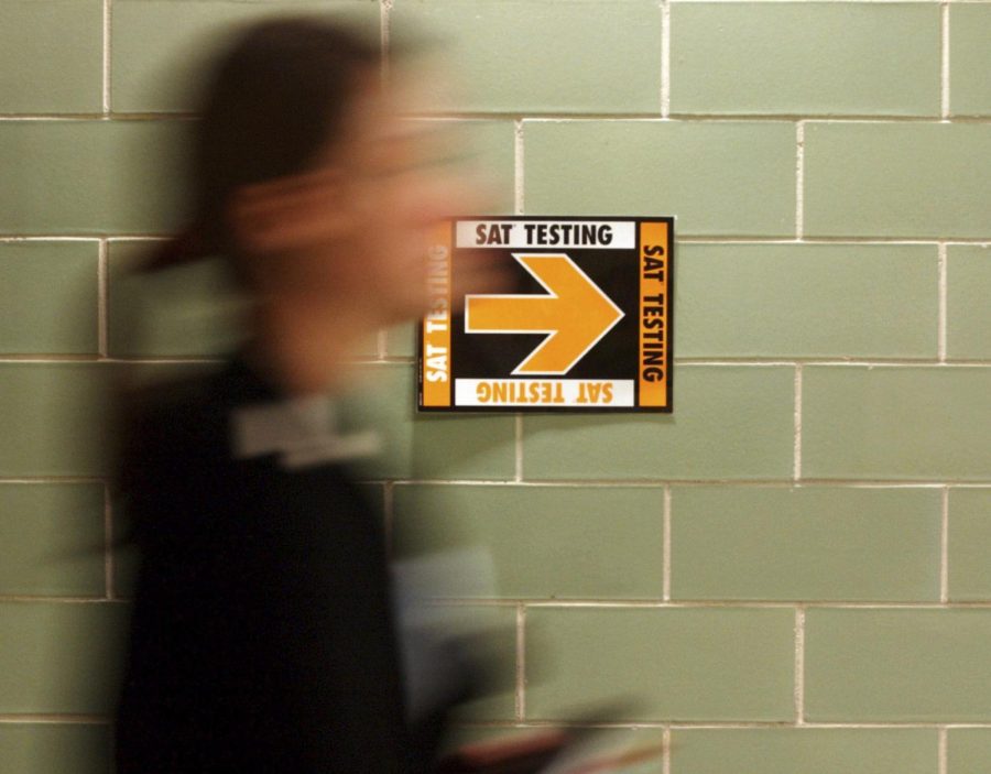 A student leaves a testing room after finishing their SAT.