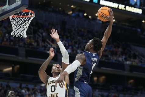 Saint Peters KC Ndefo (11) goes up for a dunk against Murray States KJ Williams (0) during a game in the second round of the NCAA tournament, Saturday, March 19, 2022, in Indianapolis.