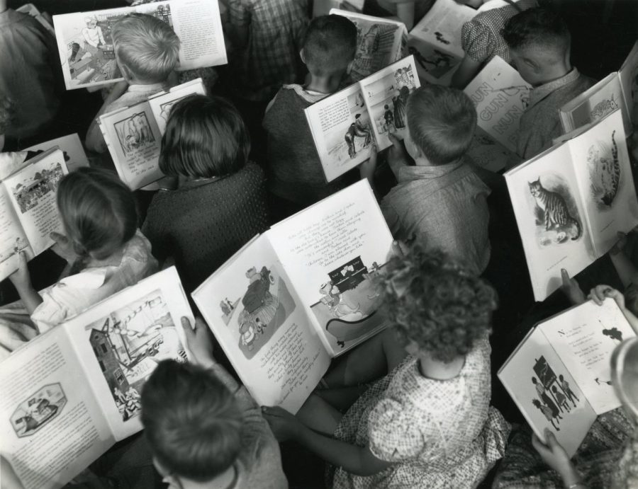 "Children reading c.1960 'Celebrating World Book Day'" by Archives New Zealand is licensed under CC BY 2.0. To view a copy of this license, visit https://creativecommons.org/licenses/by/2.0/?ref=openverse.