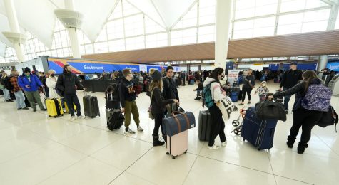 Photo Creds to AP Images. Travelers queue up to check in at the Southwest Airlines counter in Denver International Airport on Dec. 23, 2022.
