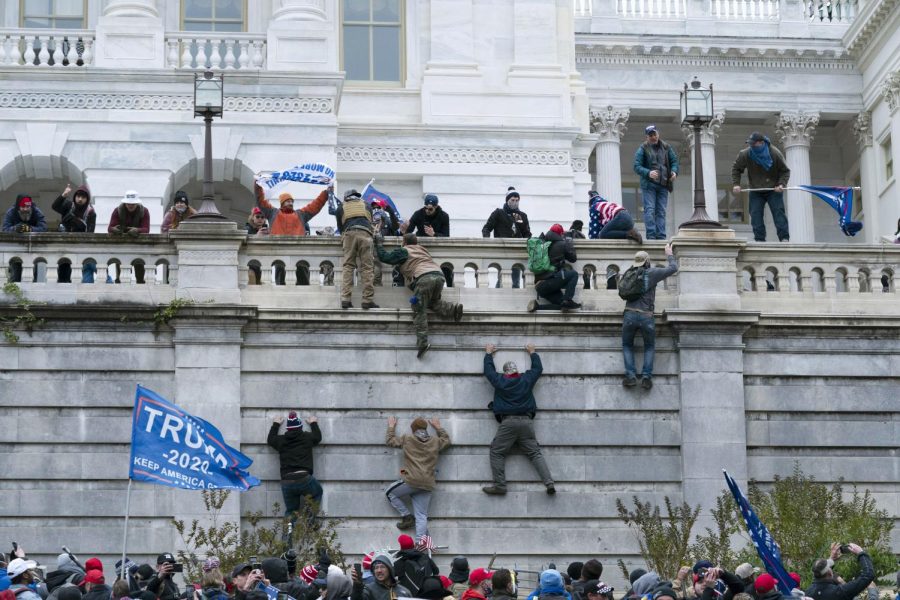 People storm the Capitol building during the Jan. 6 insurrection in 2021.