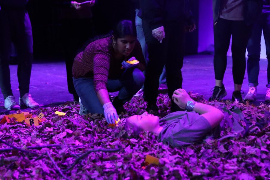 Junior Saisrivarsha Venigalla places evidence markers around the scene on the EHS auditorium on Jan. 23, 2023.