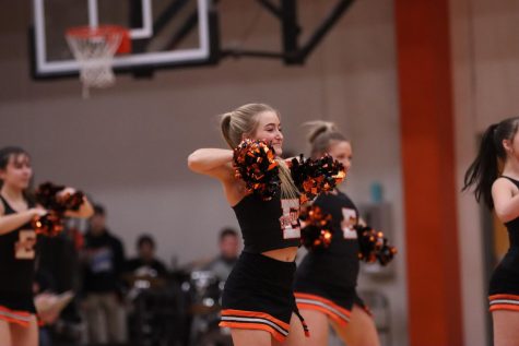 Sophomore Addison Keller dances at the halftime show at the boys basketball game against Alton. 