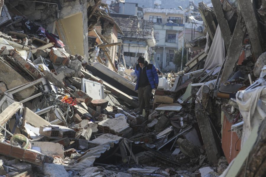 A man walks among the debris of collapsed buildings in Hatay, southern Turkey, Thursday, Feb. 9, 2023. Emergency crews made a series of dramatic rescues in Turkey on Friday, pulling several people, some almost unscathed, from the rubble, four days after a catastrophic earthquake killed more than 20,000. 