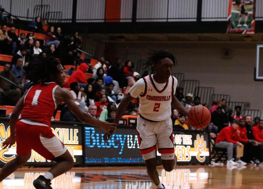 Junior Malik Allen dribbles past an Alton defender at EHS on Jan. 13. The Tigers won 57-40.