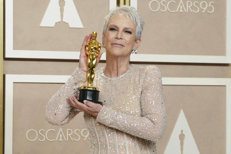 Jamie Lee Curtis poses with the award for Best Performance by an Actress in a Supporting Role for Everything Everywhere All at Once in the press room at the Oscars on March 12.