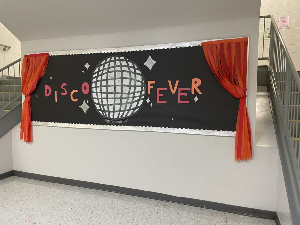 The bulletin board in the main staircase is decorated to match the "Let's Groove Tonight" theme. 