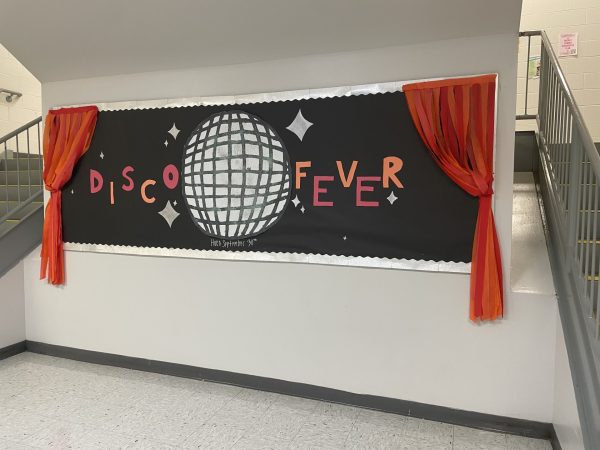 The bulletin board in the main staircase is decorated to match the Lets Groove Tonight theme. 