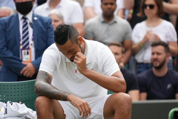 Nick Kyrgios takes a changeover during Wimbledon 2021.