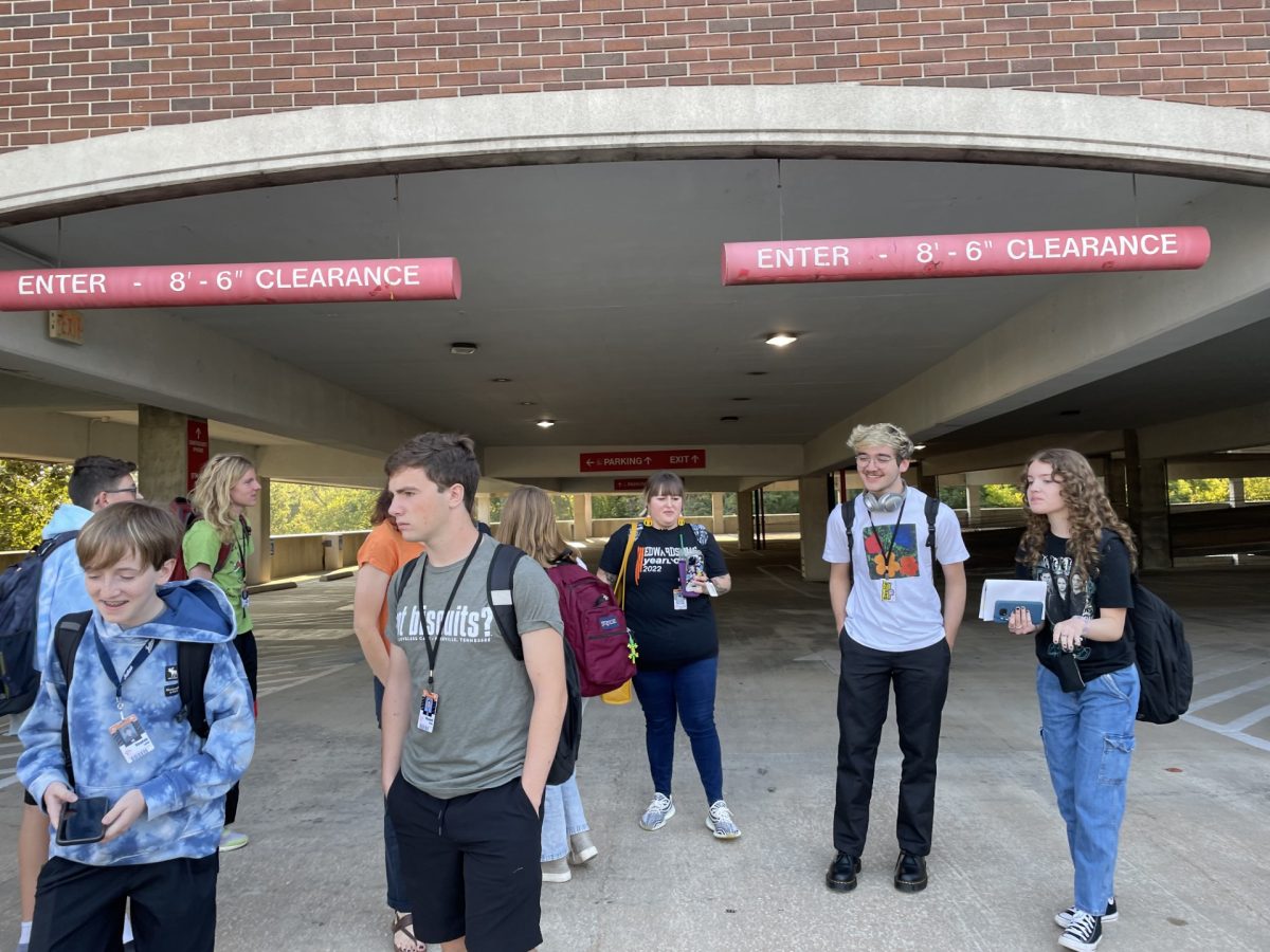 The yearbook staff walks under the red clearance sign on their way out of the parking garage. 
