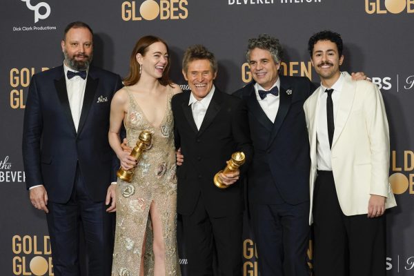Poor Things cast celebrating their two wins at the 81st Golden Globes.