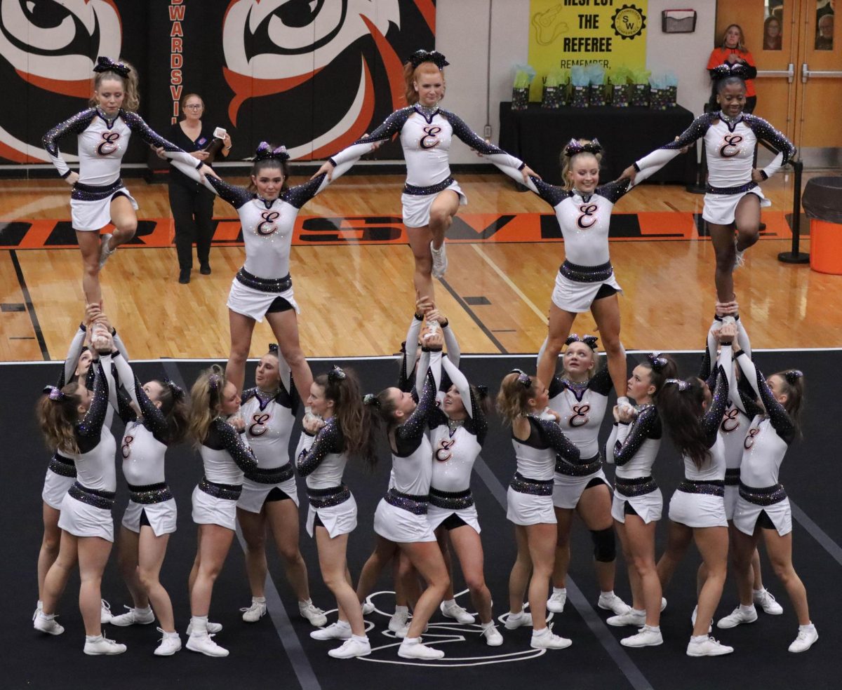 The cheer team perfroms a stunt a Dec. 17 cheer competition.