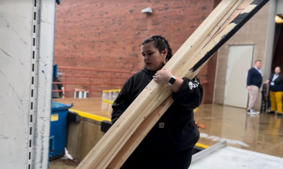 Senior Sam Bock, techie and Drama Club historian, reloads spare boards into a trailer after the Jan. 12 performance of "Pippin!" at Illinois State University.